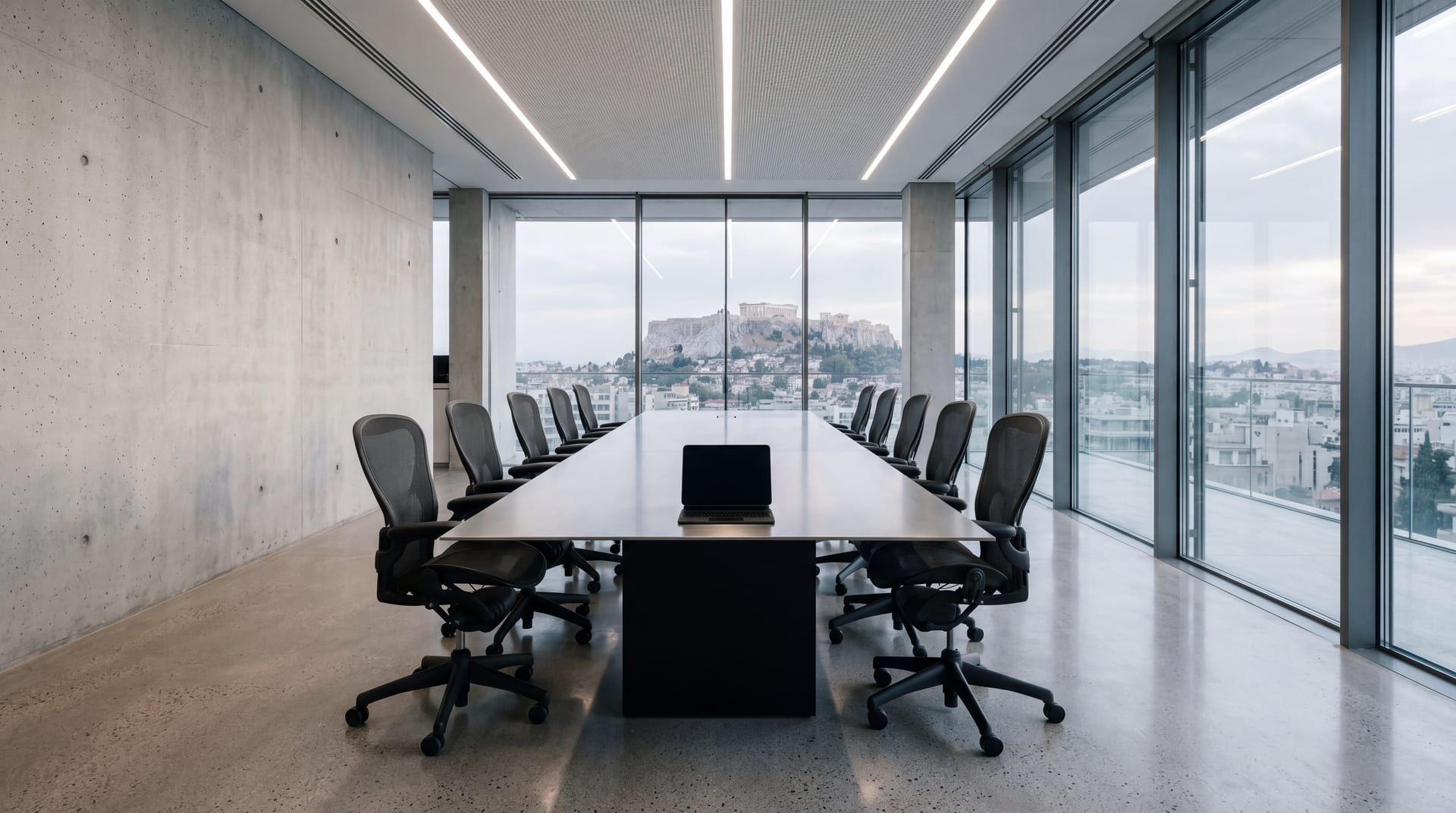 Empty contemporary Athens advisory boardroom, brushed-steel table with a single iPad, glass wall to Acropolis in late-afternoon light